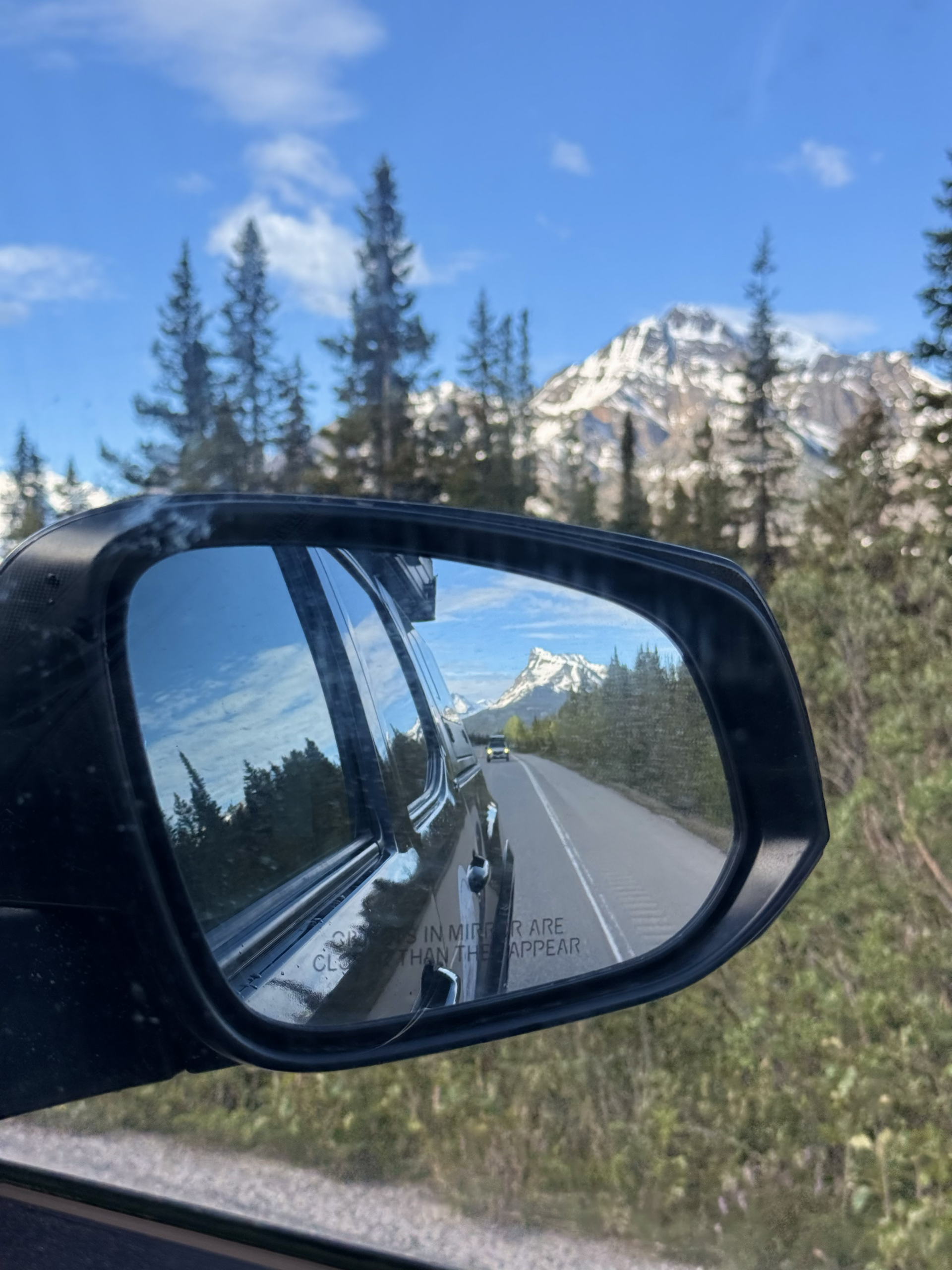 mountain road reflection in car side mirror, Canada