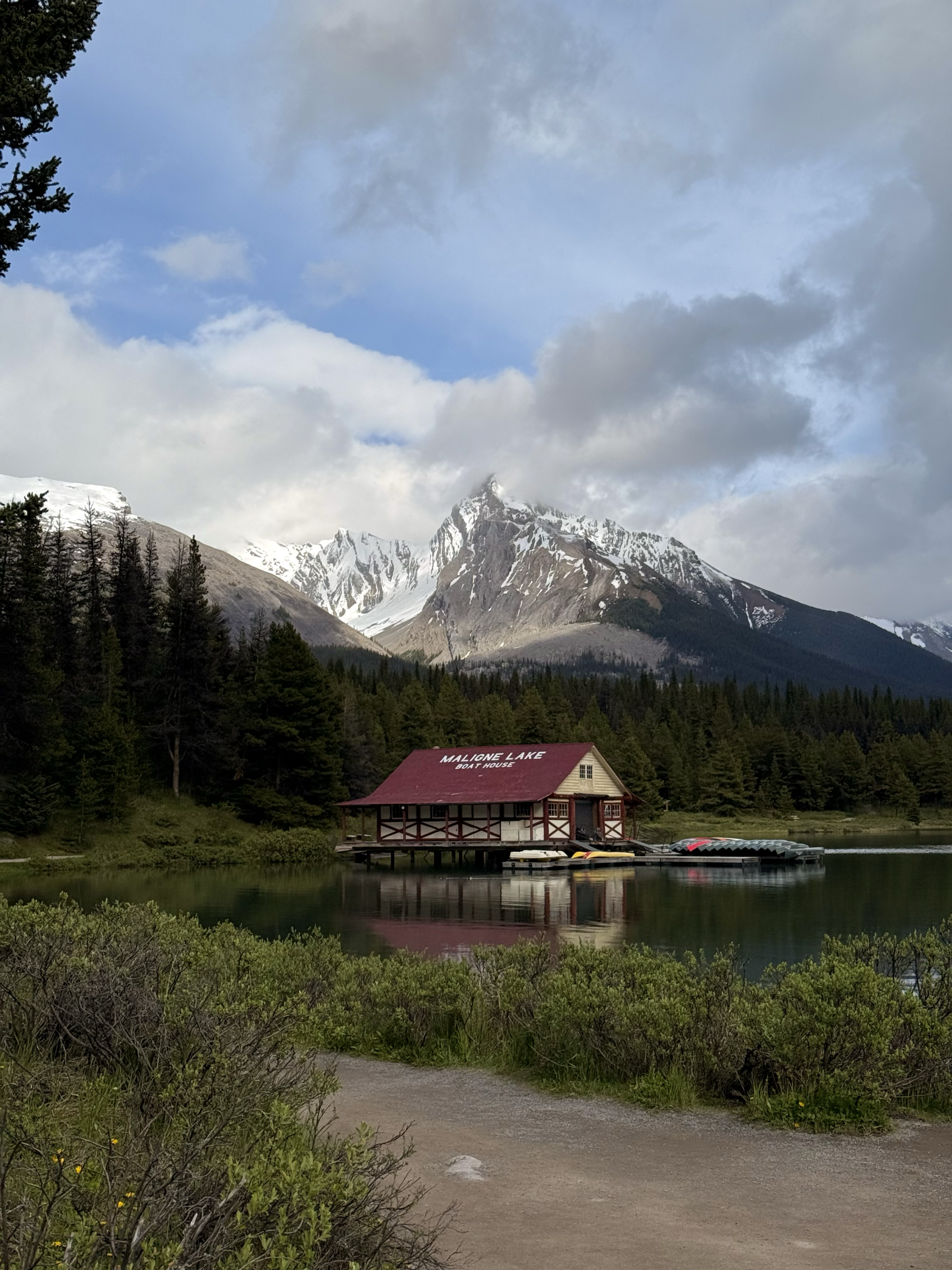Maligne Lake Boat House with snowy mountains and forest