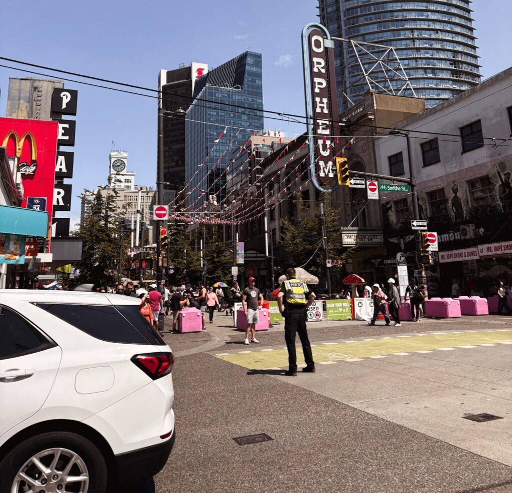 street scene with Orpheum Theatre sign and people in Vancouver